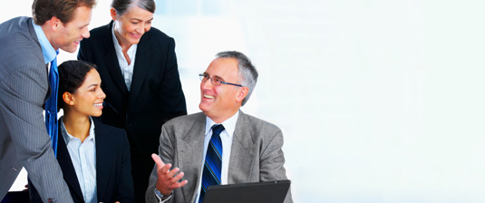 FAQ Image Business Professionals gathered around a computer